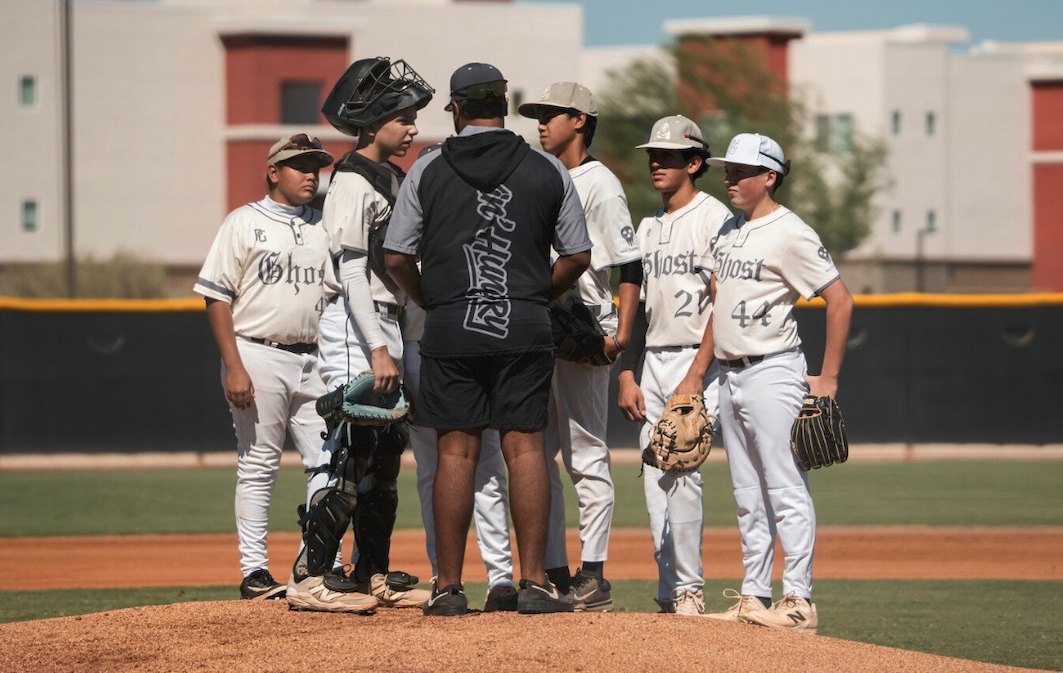 Coach Gutz talking with his infield during a mound visit